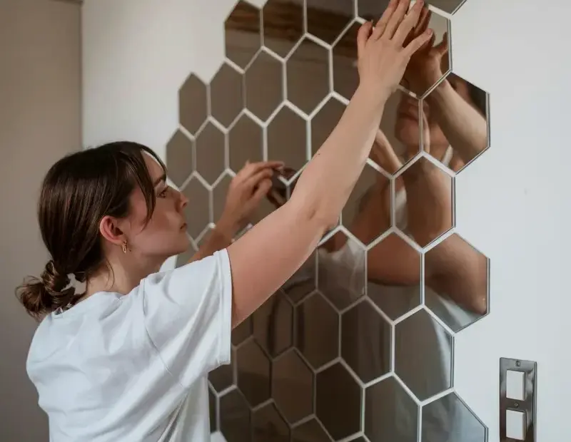 Bronze hexagon mirror tiles honeycomb pattern installation